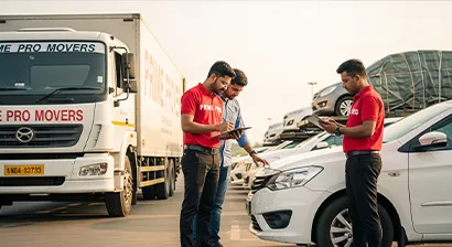 Team member inspecting a car before loading at a transport terminal with the customer in Gurugram